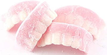 Barratts Milk Teeth 2.5kg Bulk Bag - Approximately 450 iconic strawberry and vanilla flavoured soft foam sweets in fun tooth shapes by Barratts of England.